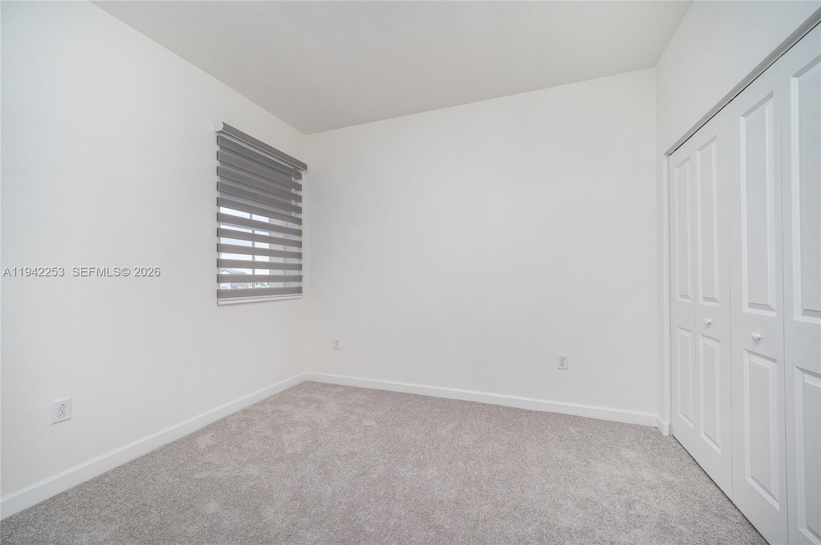 2747 Southeast 26th Road, Unit 2747 Homestead, FL 33035 - Photo 17 of 27 a view of an empty room with a window