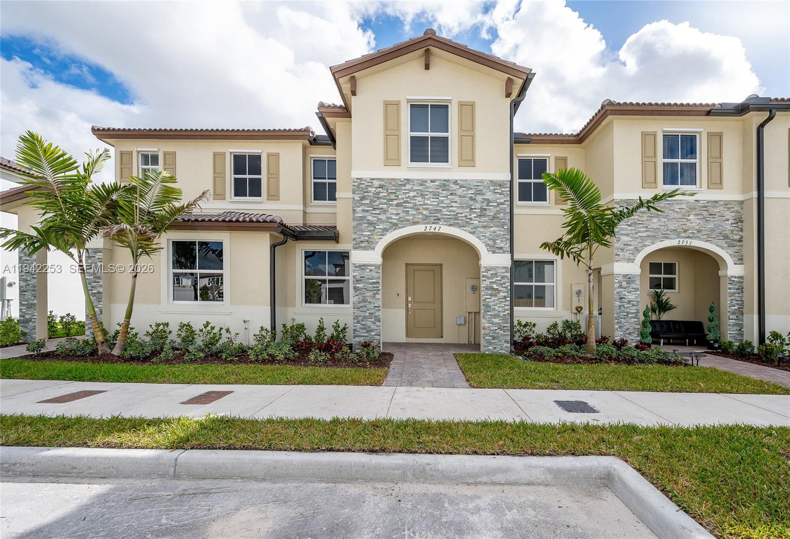 2747 Southeast 26th Road, Unit 2747 Homestead, FL 33035 - Photo 18 of 27 a front view of a house with a garden