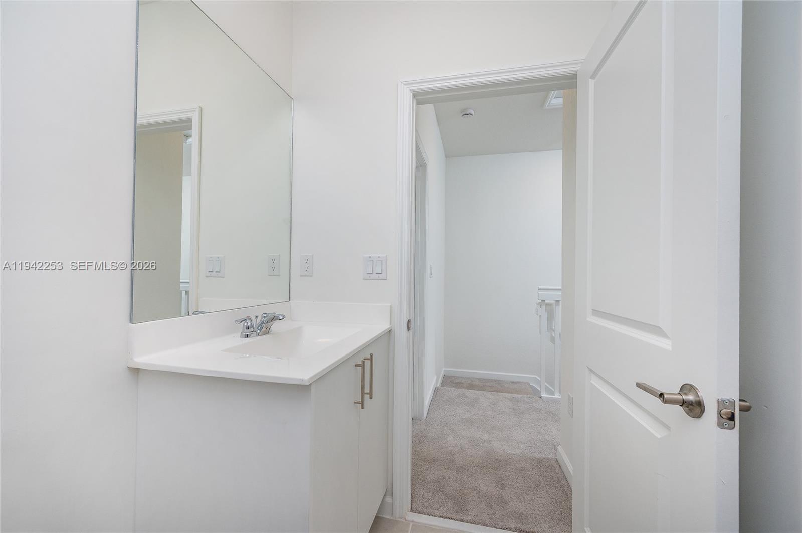 2747 Southeast 26th Road, Unit 2747 Homestead, FL 33035 - Photo 25 of 27 a bathroom with a sink and mirror