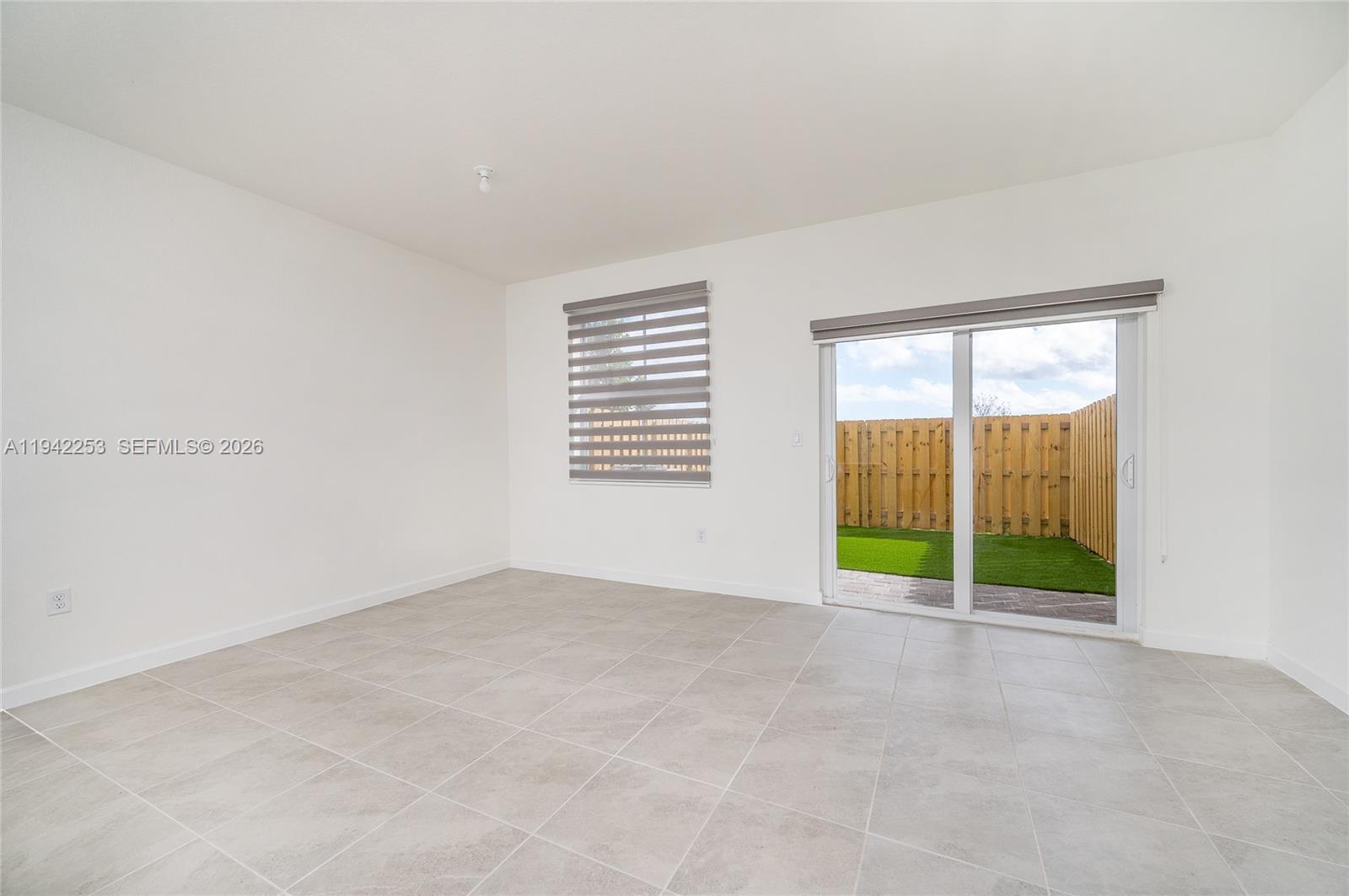 2747 Southeast 26th Road, Unit 2747 Homestead, FL 33035 - Photo 5 of 27 a view of an empty room with a window