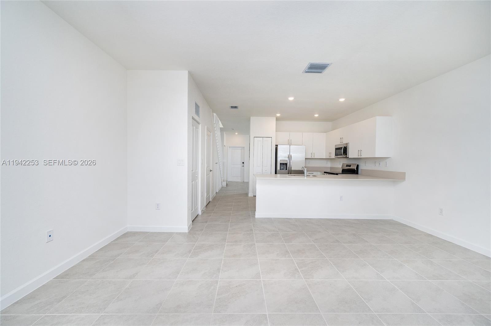 2747 Southeast 26th Road, Unit 2747 Homestead, FL 33035 - Photo 8 of 27 a view of kitchen with refrigerator and a fireplace