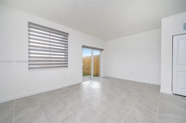 a room with white cabinets and sink