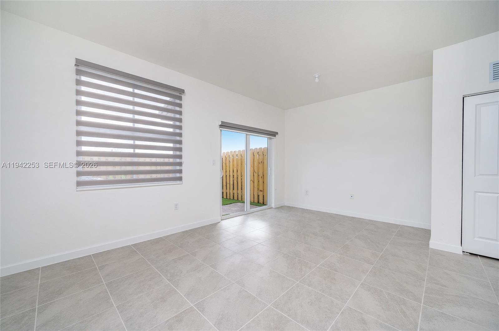 2747 Southeast 26th Road, Unit 2747 Homestead, FL 33035 - Photo 10 of 27 a view of an empty room with a window