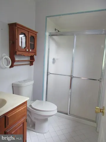 a bathroom with a toilet a sink and shower