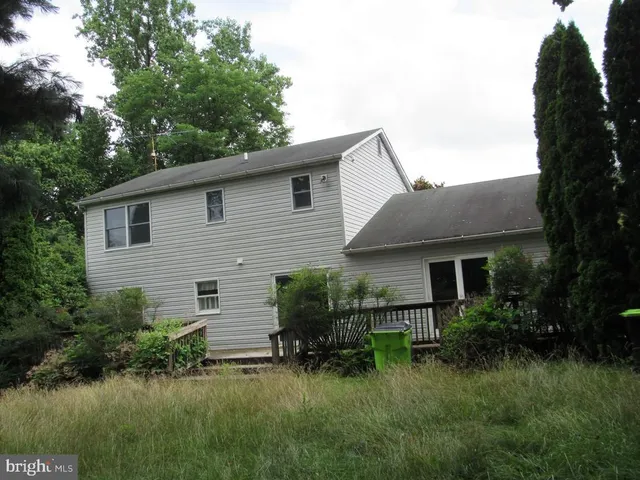 a backyard of a house with plants and garden