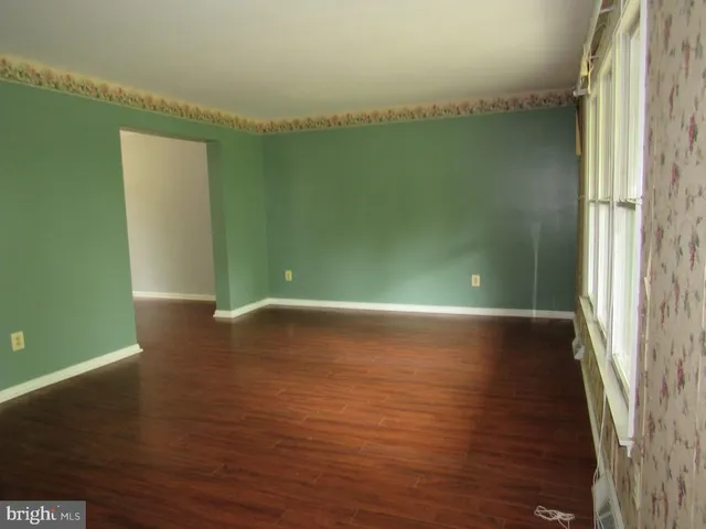 a view of a room with wooden floor and a lake view
