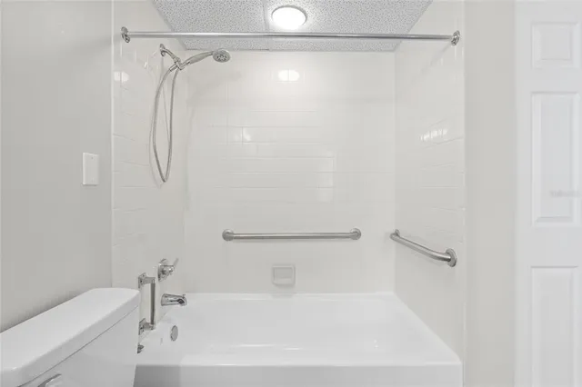 a bathroom with a bath tub with a shower