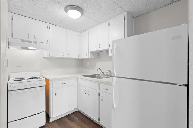 a kitchen with appliances cabinets and a sink