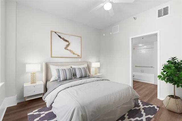 a bedroom with a bed and a potted plant