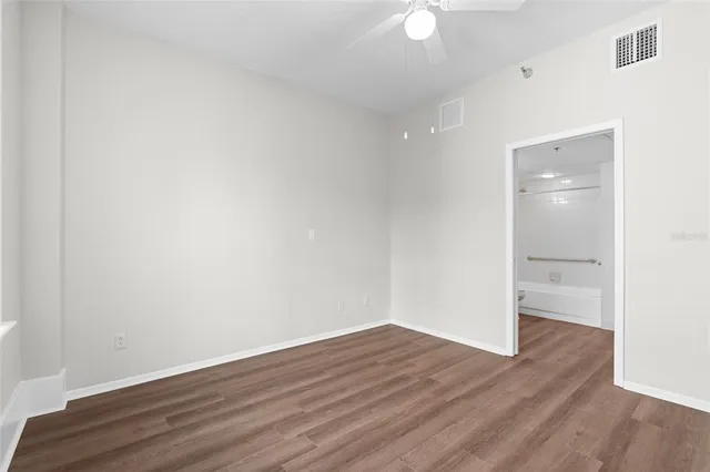 a view of an empty room with wooden floor