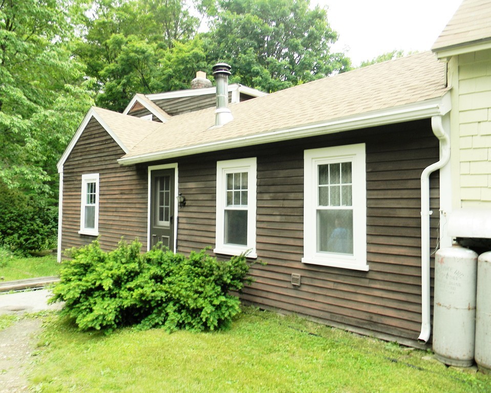 18 Flat Rock Road Petersham, MA 01366 - Photo 3 of 26 a front view of a house with a garden
