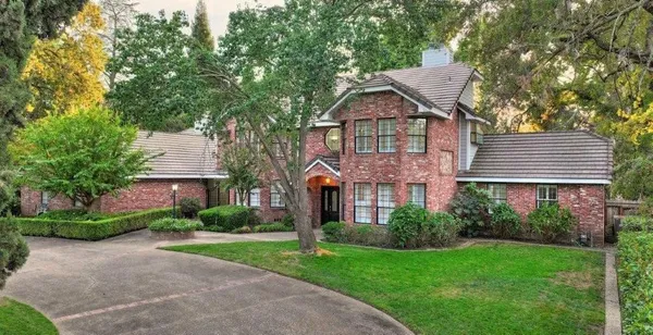 a front view of house with yard and green space