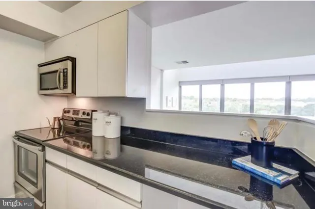 a kitchen with a refrigerator and window