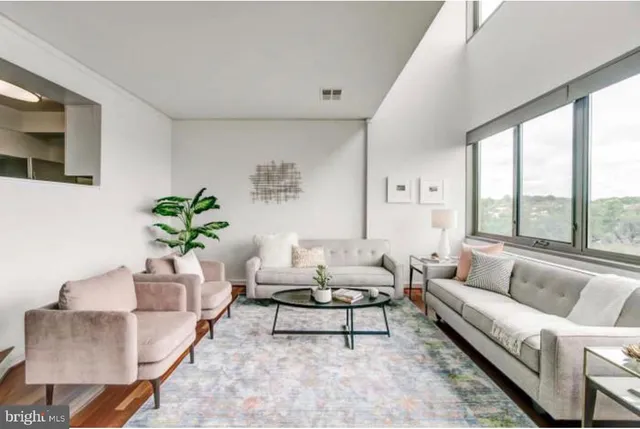a living room with furniture and a large window