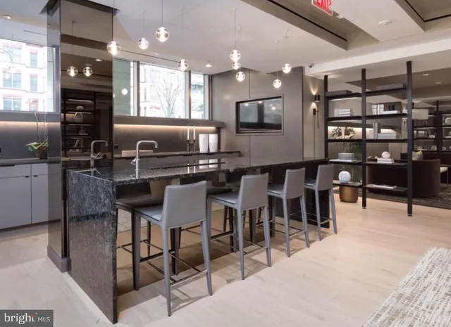 a kitchen with lots of counter top space and furniture