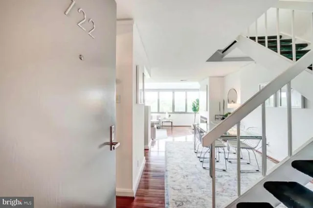 a view of entryway and hall with wooden floor