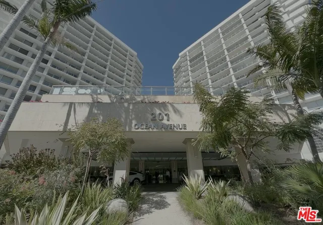 a view of building with potted plants and a bench