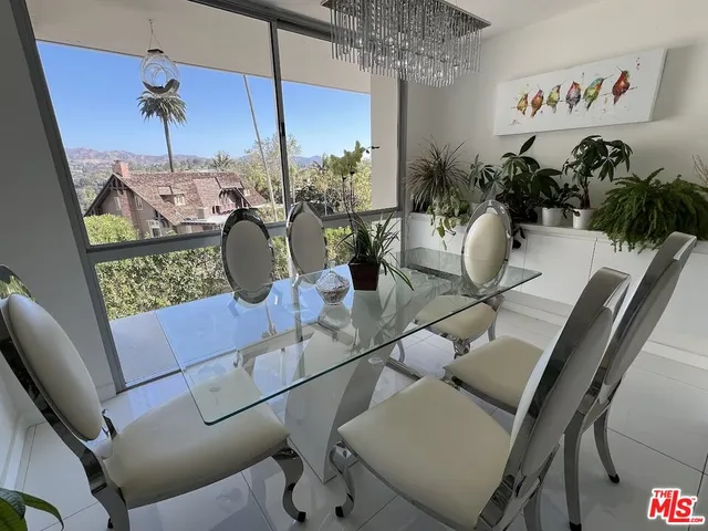 a view of a dining room with furniture wooden floor and chandelier