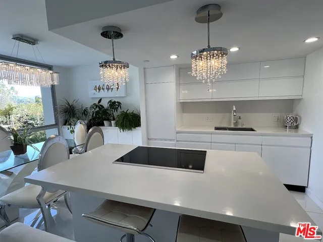 a kitchen with a table chairs and white cabinets