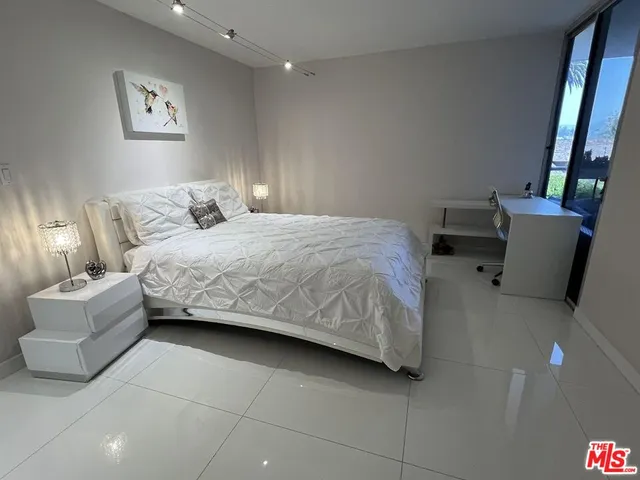 a bedroom with a bed and a couch