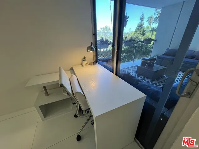 a view of a room with furniture and a window