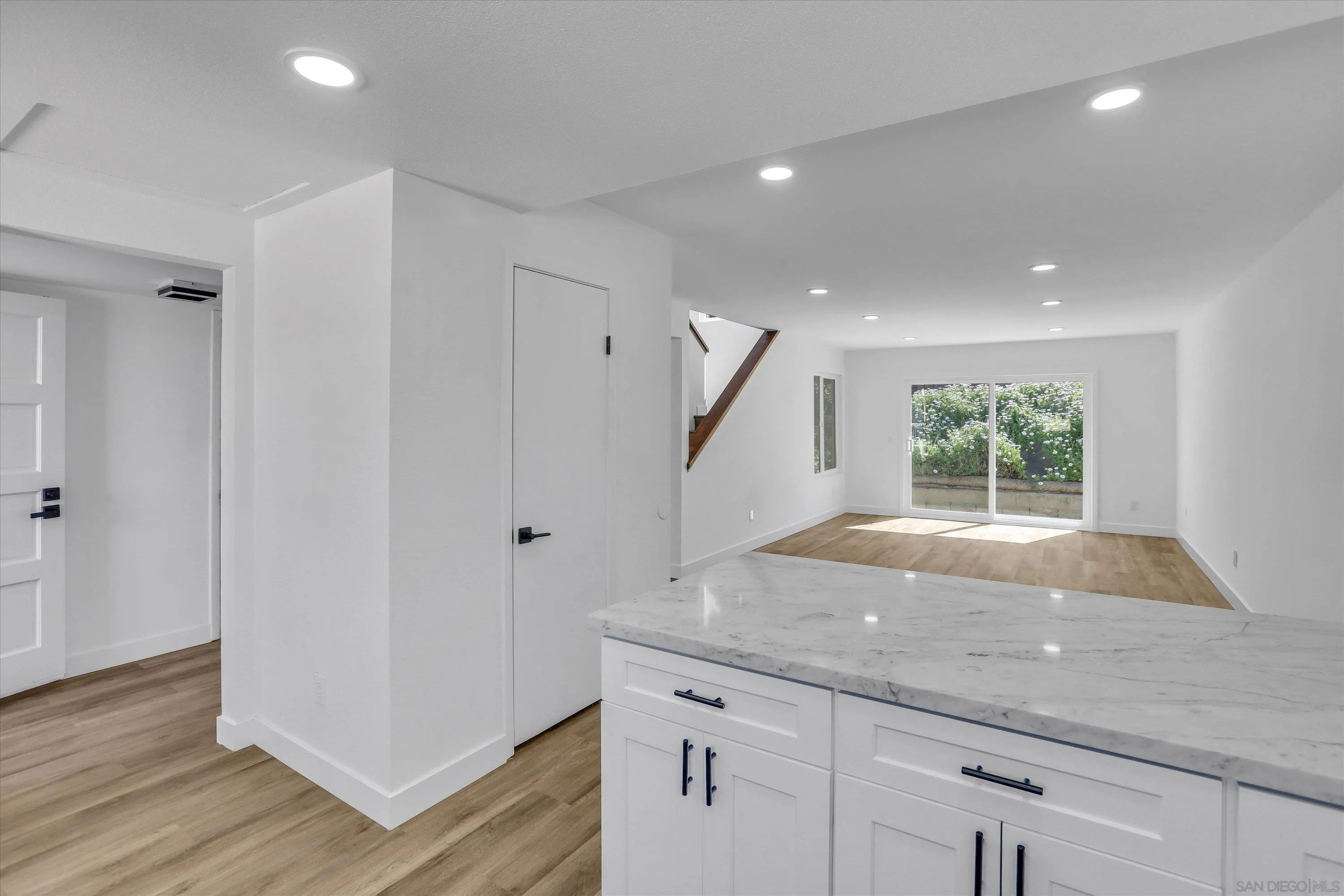 75 3rd Avenue, Unit 22 Chula Vista, CA 91910 - Photo 12 of 23 a hallway with window wooden floor and front door