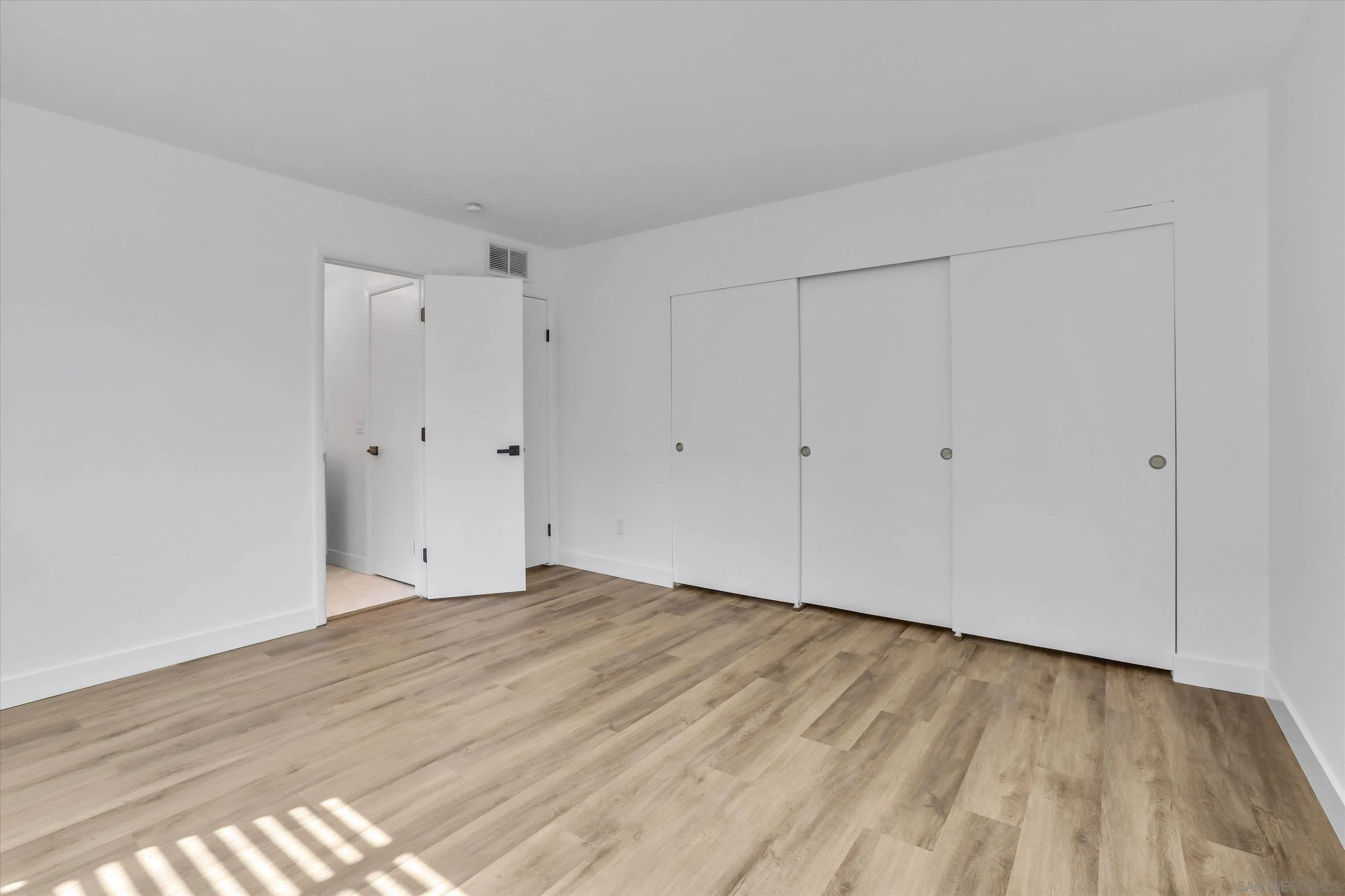 75 3rd Avenue, Unit 22 Chula Vista, CA 91910 - Photo 14 of 23 a view of an empty room with wooden floor