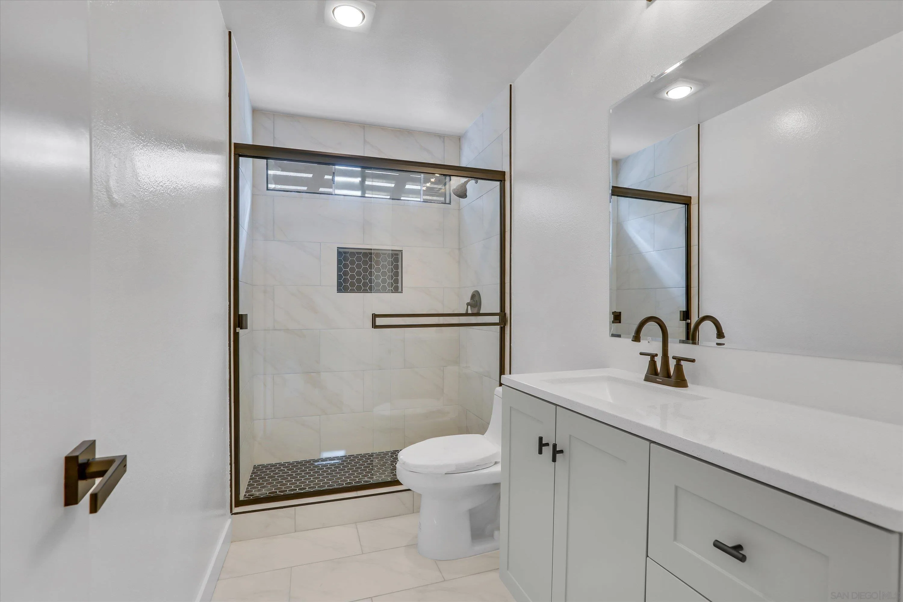 75 3rd Avenue, Unit 22 Chula Vista, CA 91910 - Photo 16 of 23 a bathroom with a sink a toilet and shower