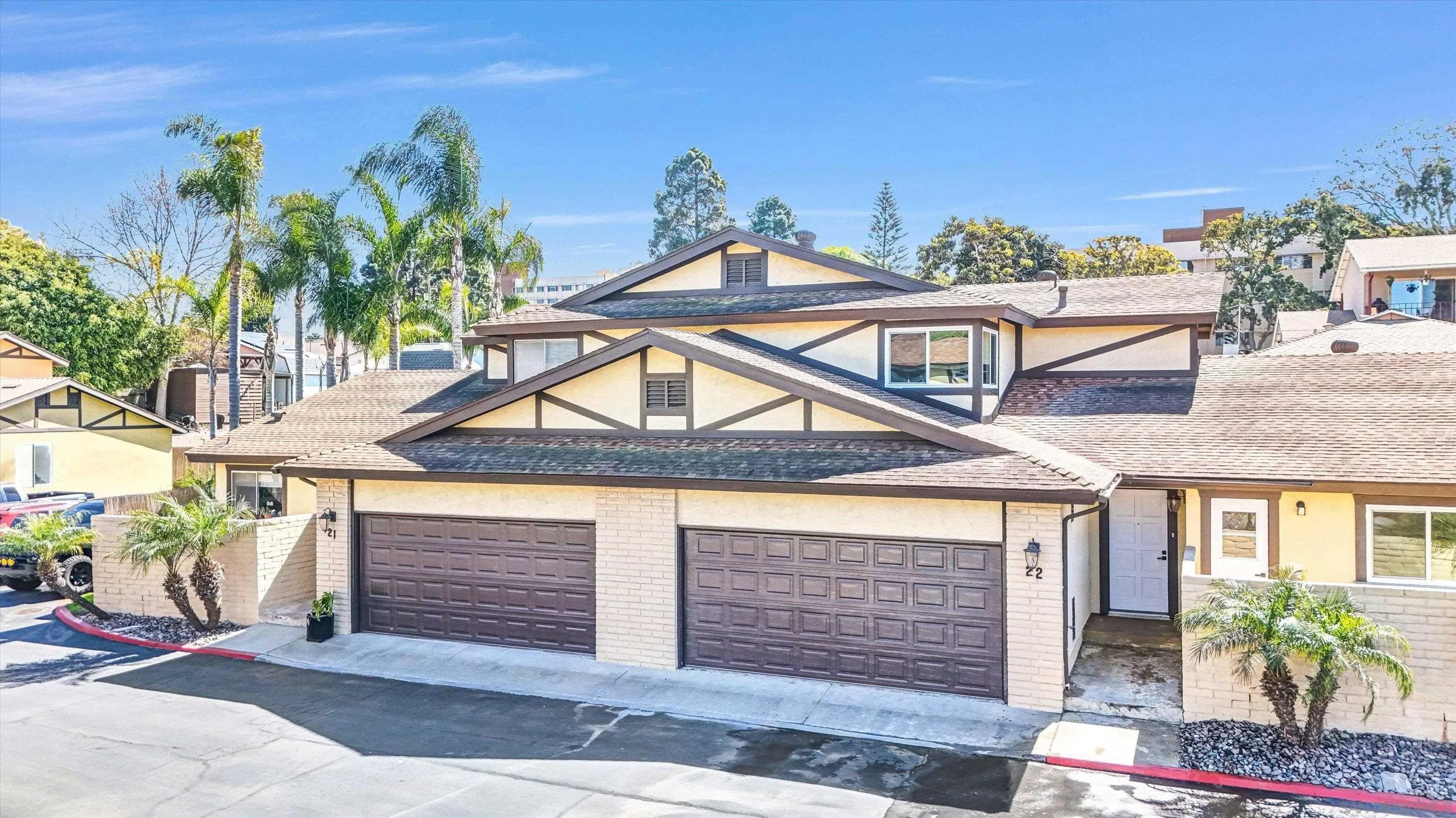 75 3rd Avenue, Unit 22 Chula Vista, CA 91910 - Photo 2 of 23 a front view of a house with a yard and garage