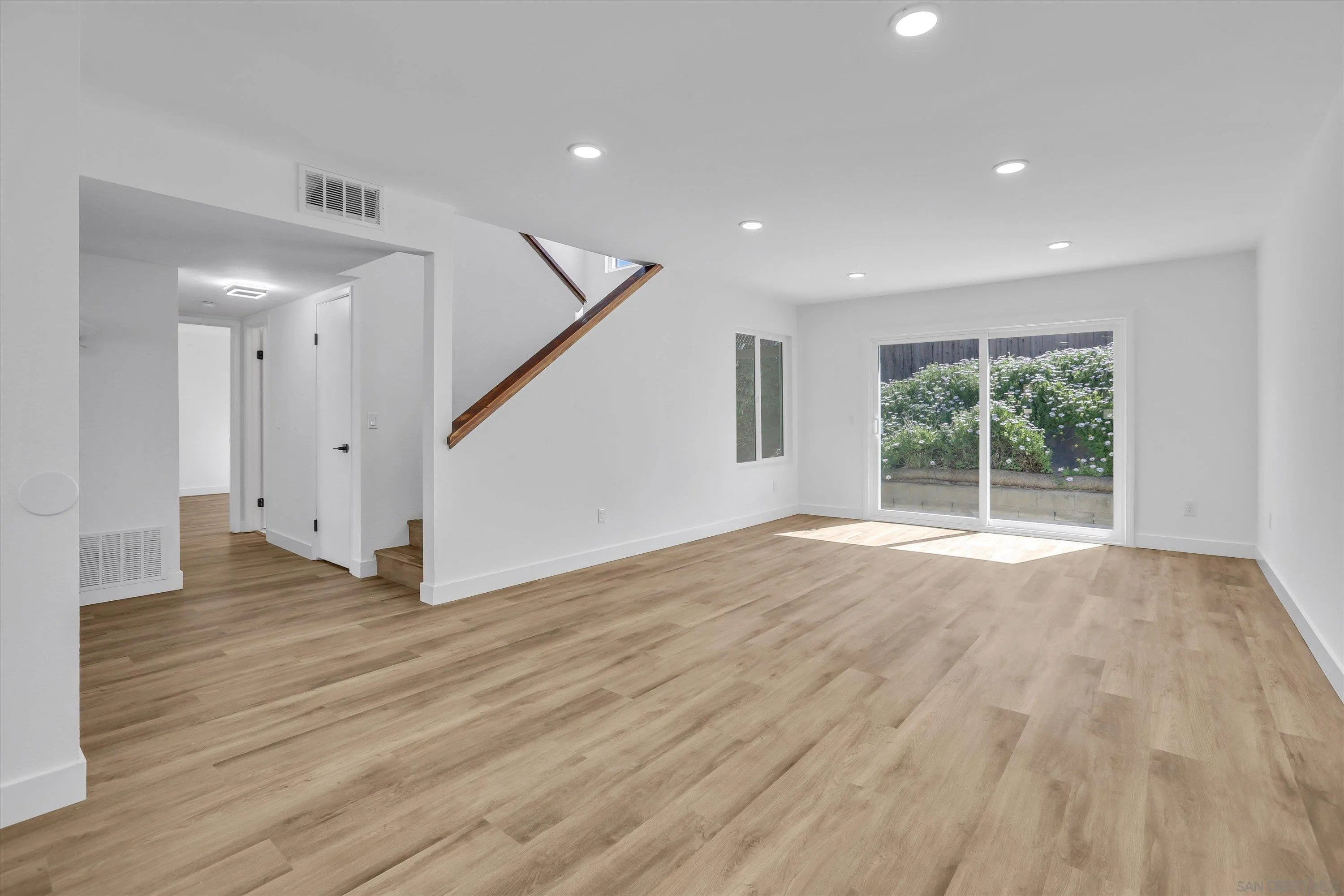 75 3rd Avenue, Unit 22 Chula Vista, CA 91910 - Photo 9 of 23 a view of an empty room with wooden floor and a window