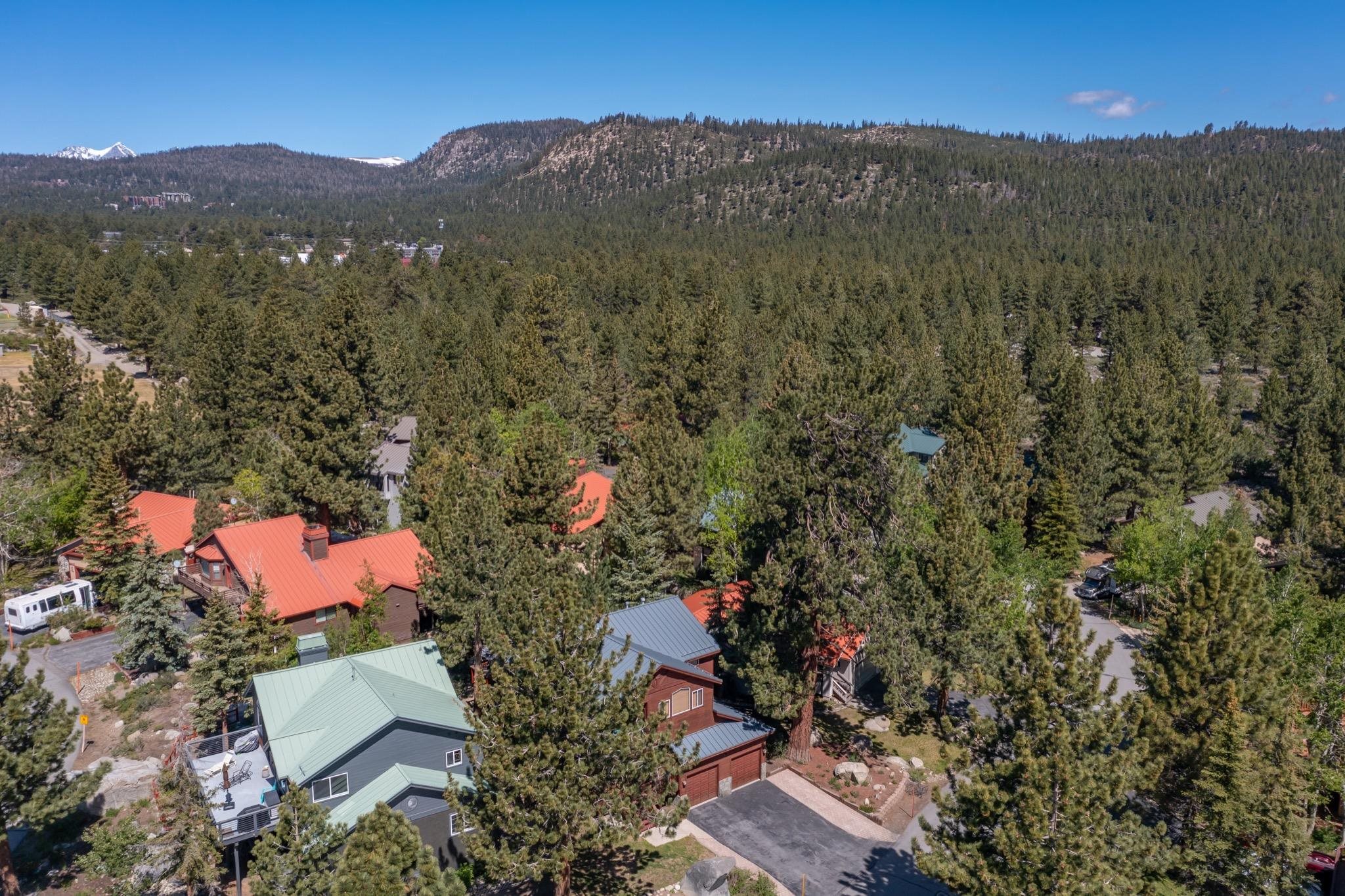 23 Trails End Road Mammoth Lakes, CA 93546 - Photo 53 of 58 Aerial perspective of a property featuring a green metal roof and an exterior deck