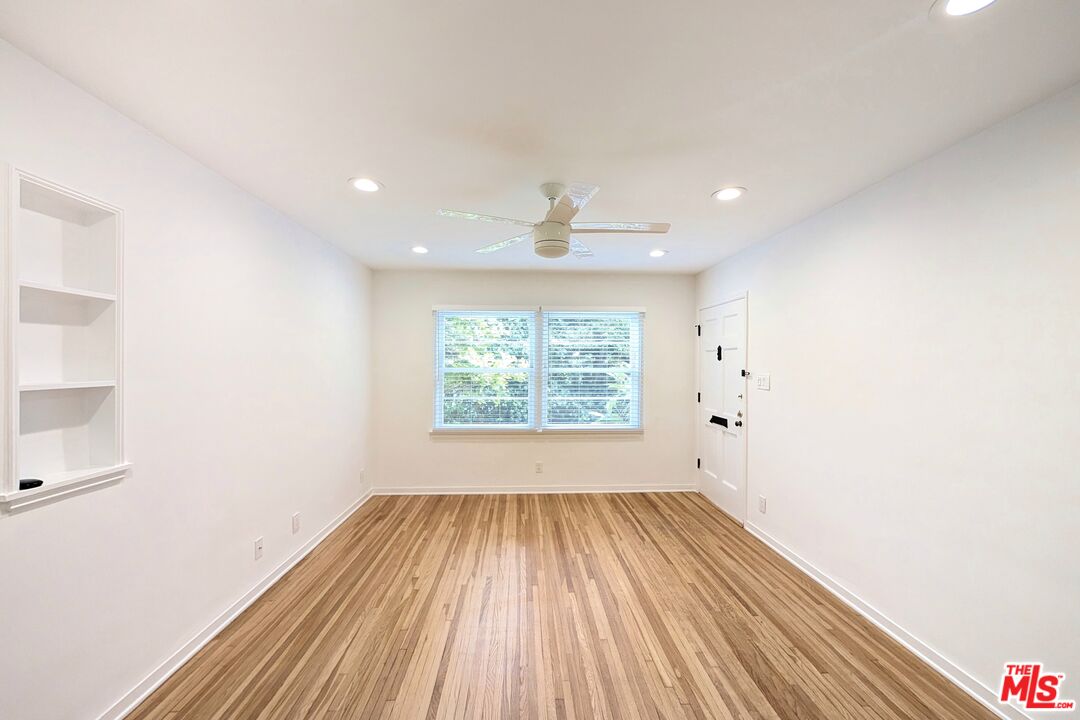 1030 5th Street, Unit C Santa Monica, CA 90403 - Photo 11 of 16 a view of an empty room with wooden floor and a window