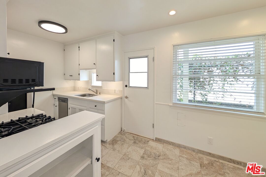 1030 5th Street, Unit C Santa Monica, CA 90403 - Photo 4 of 16 a kitchen with a stove a sink and a microwave