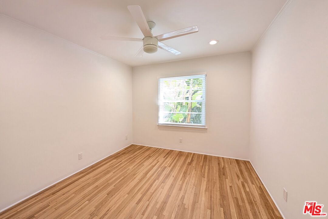 1030 5th Street, Unit C Santa Monica, CA 90403 - Photo 9 of 16 an empty room with a window and a ceiling fan
