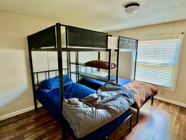 a bedroom with furniture and a window