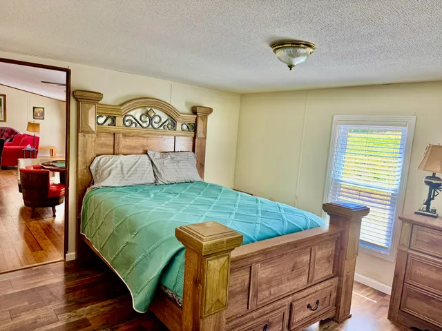 a bed sitting in a bedroom next to a window