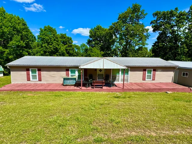 a view of a house with a yard porch and sitting area