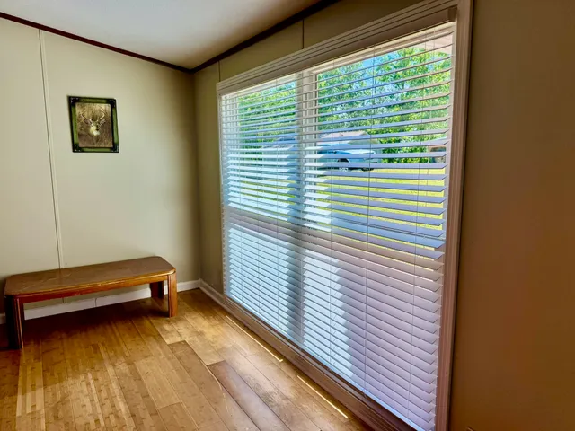 a view of a room with window and a ceiling fan