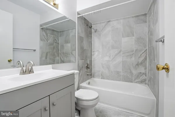 a bathroom with a sink a toilet and a bathtub