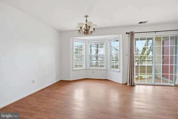 a view of livingroom with furniture wooden floor and windows
