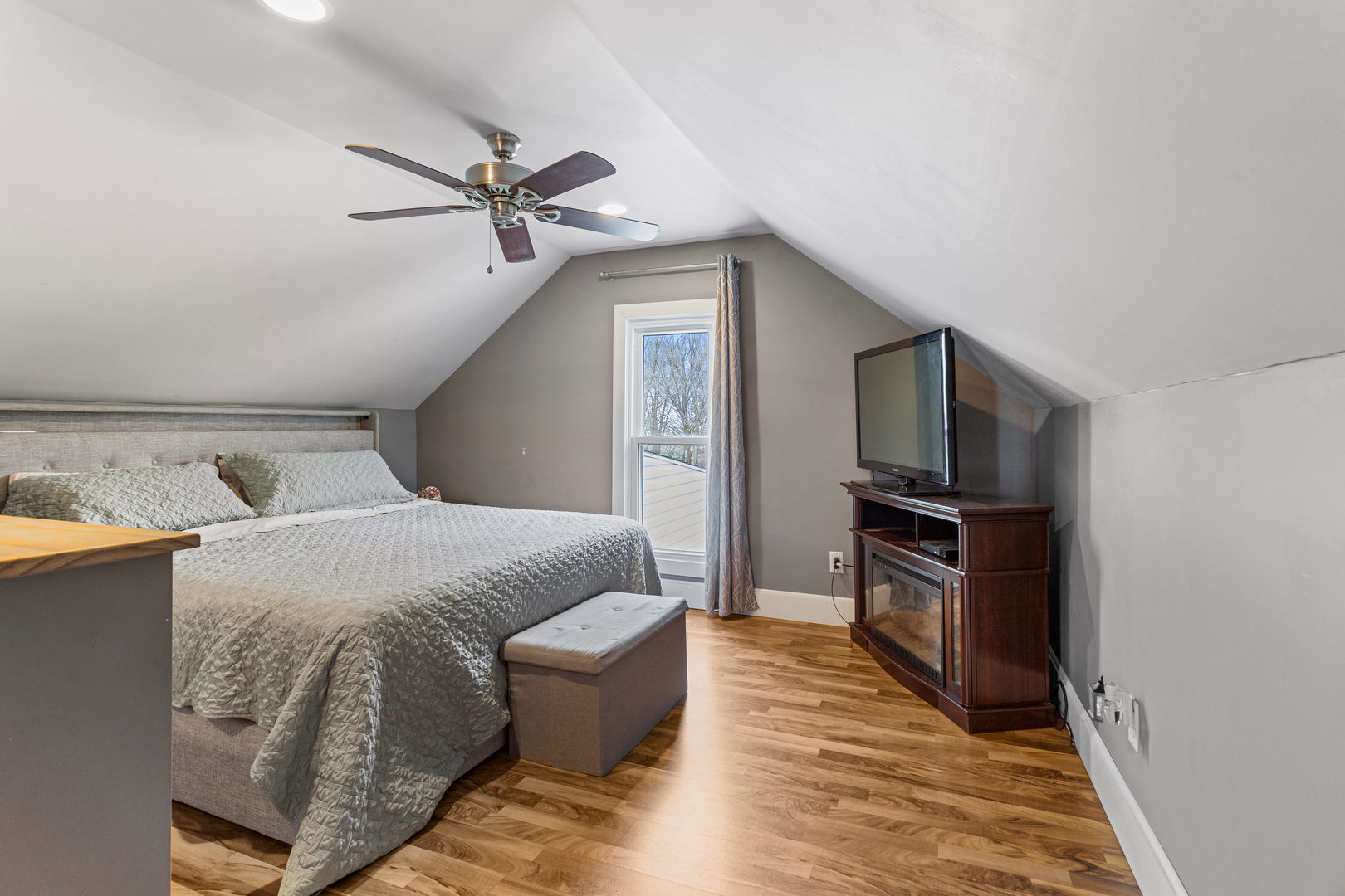 306 Shimp Road Milmine, IL 61855 - Photo 23 of 31 a bedroom with a bed wooden floor and flat screen tv