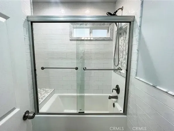a bathroom with a bathtub and shower
