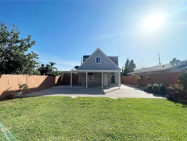 a front view of a house with a garden and yard