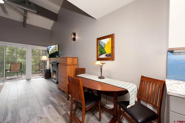 a view of a dining room with furniture and a wooden floor