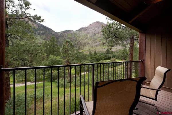 a view of a lush green forest with trees and some houses