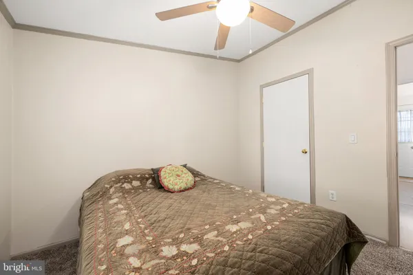 a bedroom with a bed and a wall painting