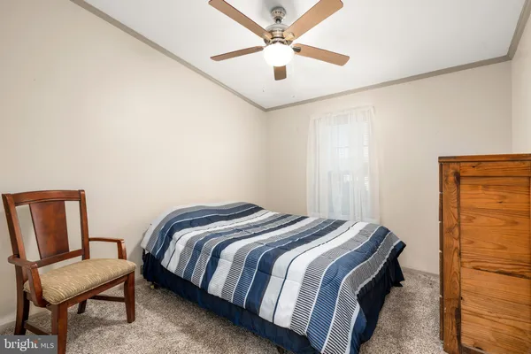a bedroom with a bed and a chair