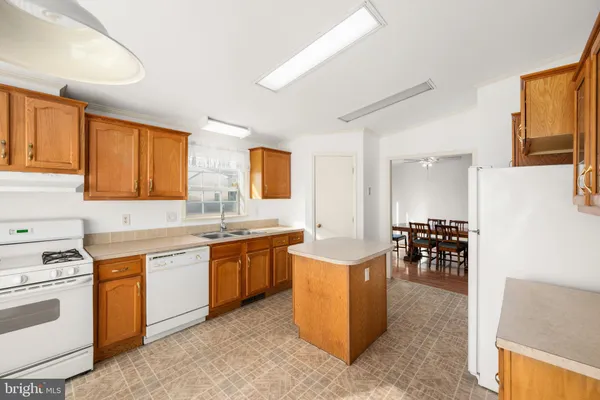 a kitchen with a sink and chairs
