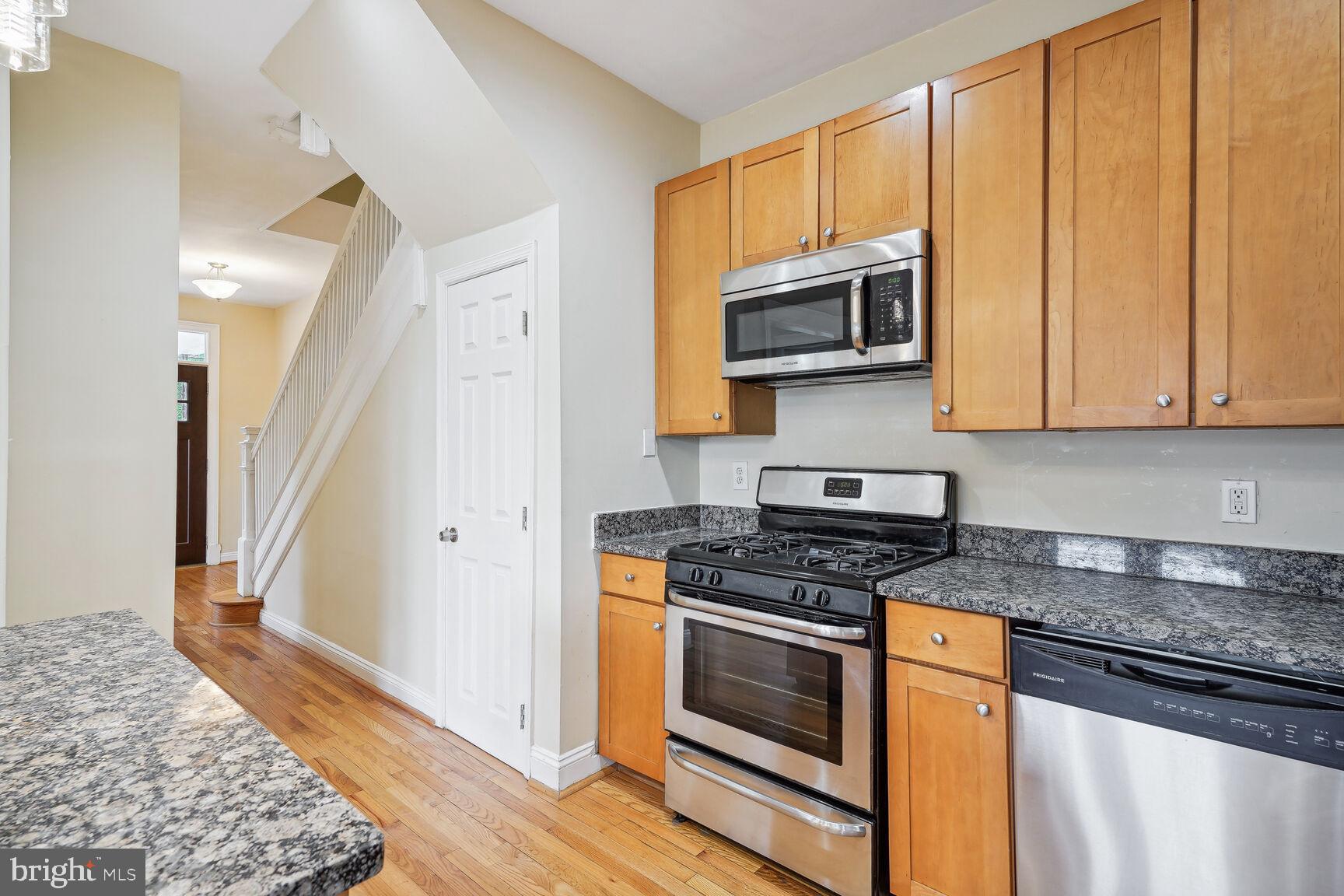 4528 4th Street Northwest Washington, DC 20011 - Photo 11 of 28 a kitchen with stainless steel appliances granite countertop a stove and a microwave