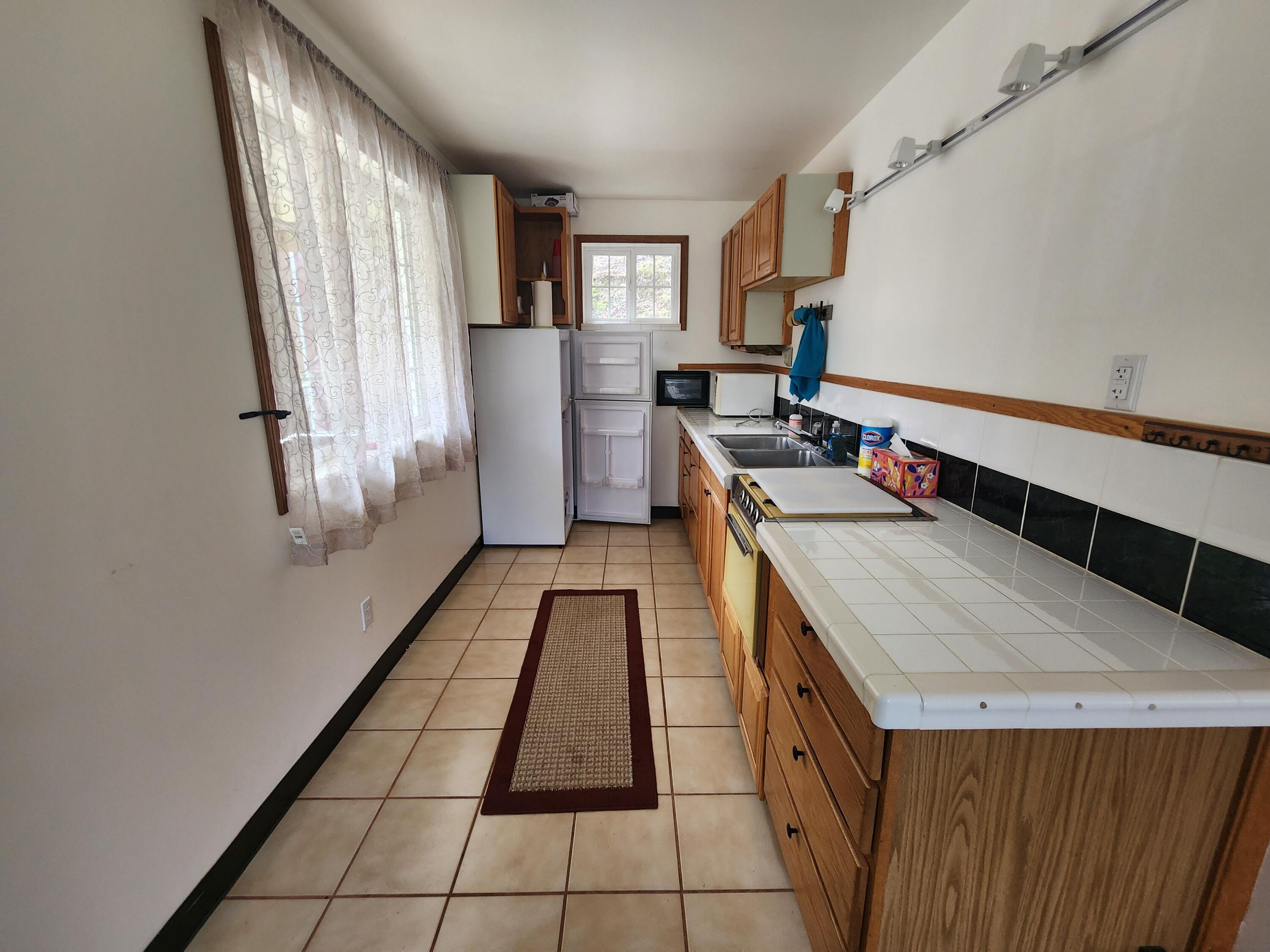 11238 East Evans Creek Road Rogue River, OR 97537 - Photo 4 of 29 a kitchen with a sink stove and cabinets